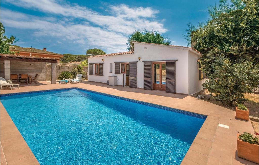 Villa con piscina frente a una casa en 3 Bedroom Cozy Home In Vidreres, en Vidreres