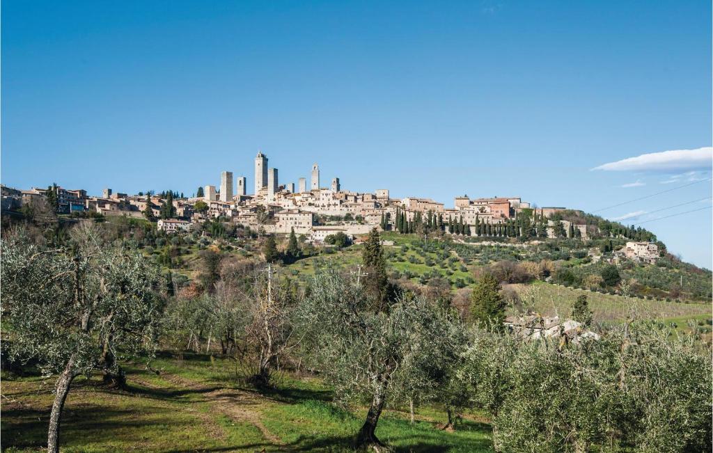 a city on top of a hill with trees at Casa Martina in San Gimignano