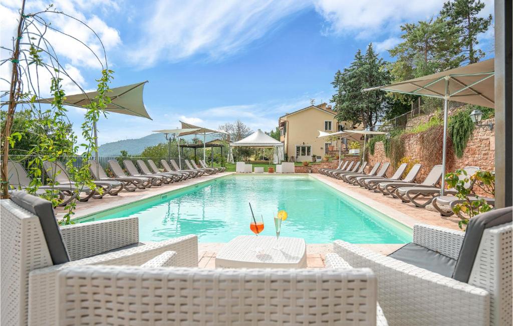 a swimming pool with chairs and a table and a pool at Flora House 1 in Macerino