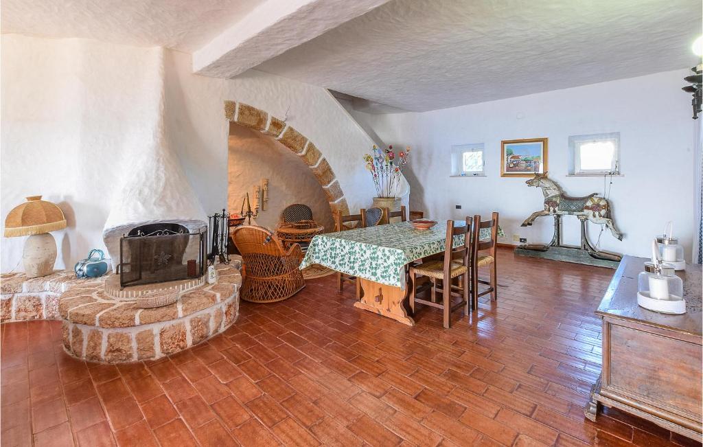 a living room with a table and a fireplace at Villa Antica in Stalettì
