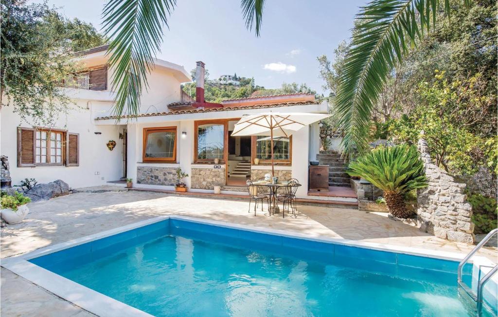 a villa with a swimming pool in front of a house at Casa Stranges in Copanello