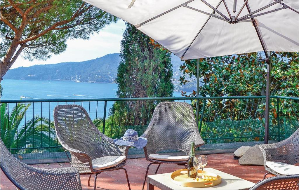 a patio with chairs and a table and an umbrella at Villa Valentini in San Michele di Pagana