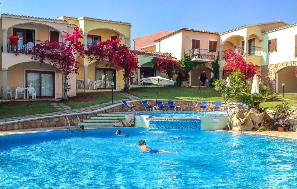 a person swimming in a swimming pool in a house at Mono 2 in Badesi