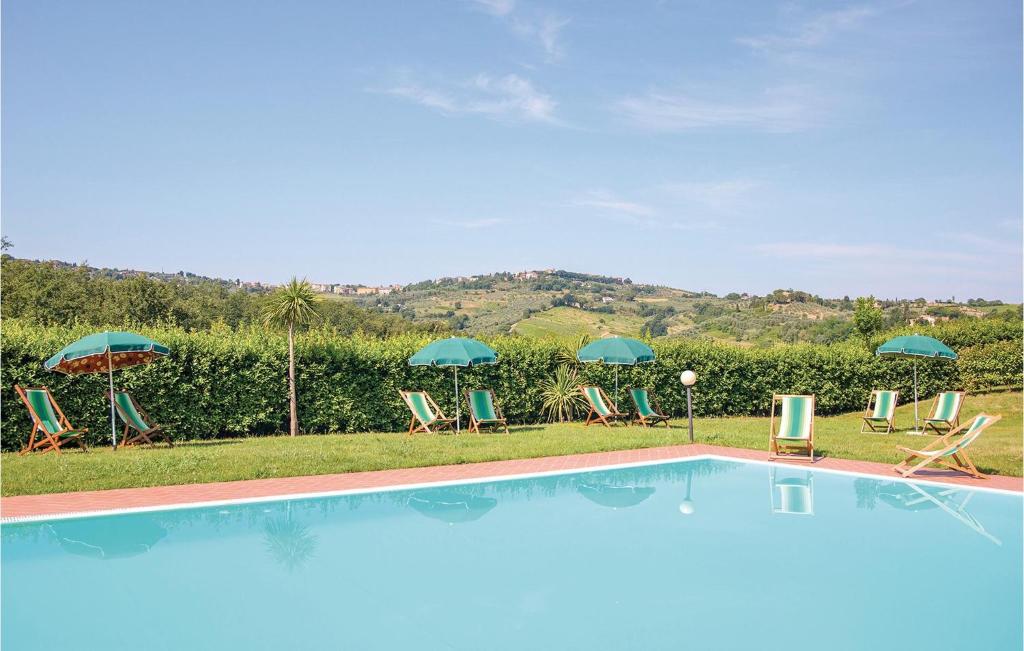 a swimming pool with chairs and umbrellas at Casale Del Borgo 6 in Querce