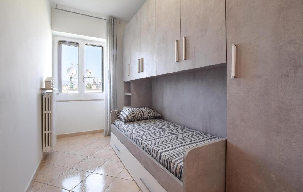 A bed or beds in a room at 2 Bedroom Lovely Apartment In Siponto