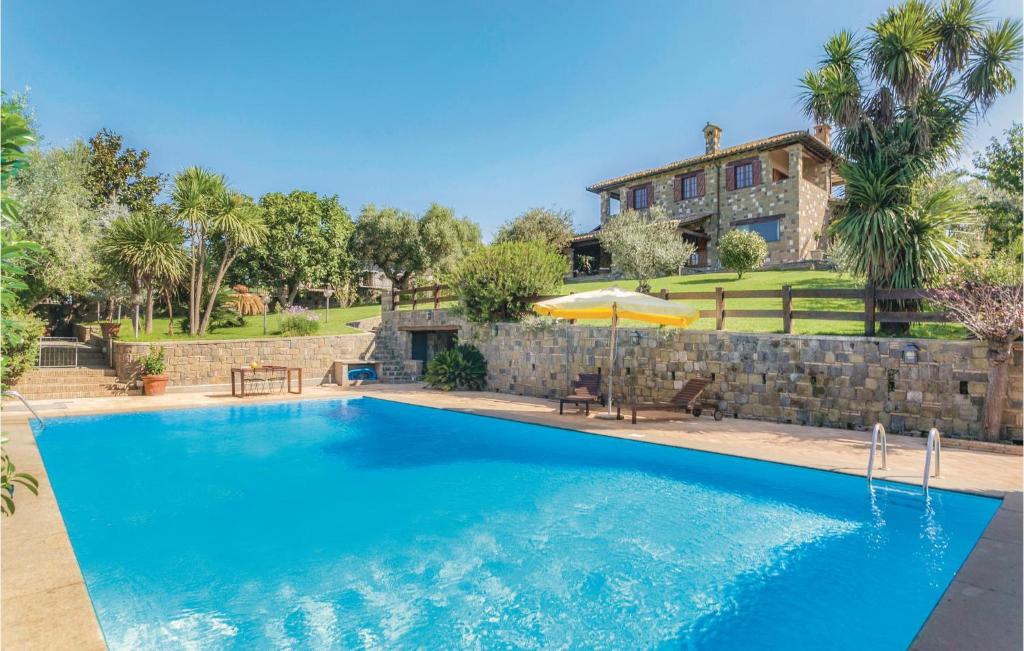 a large swimming pool in front of a house at La Magnolia in Anguillara Sabazia