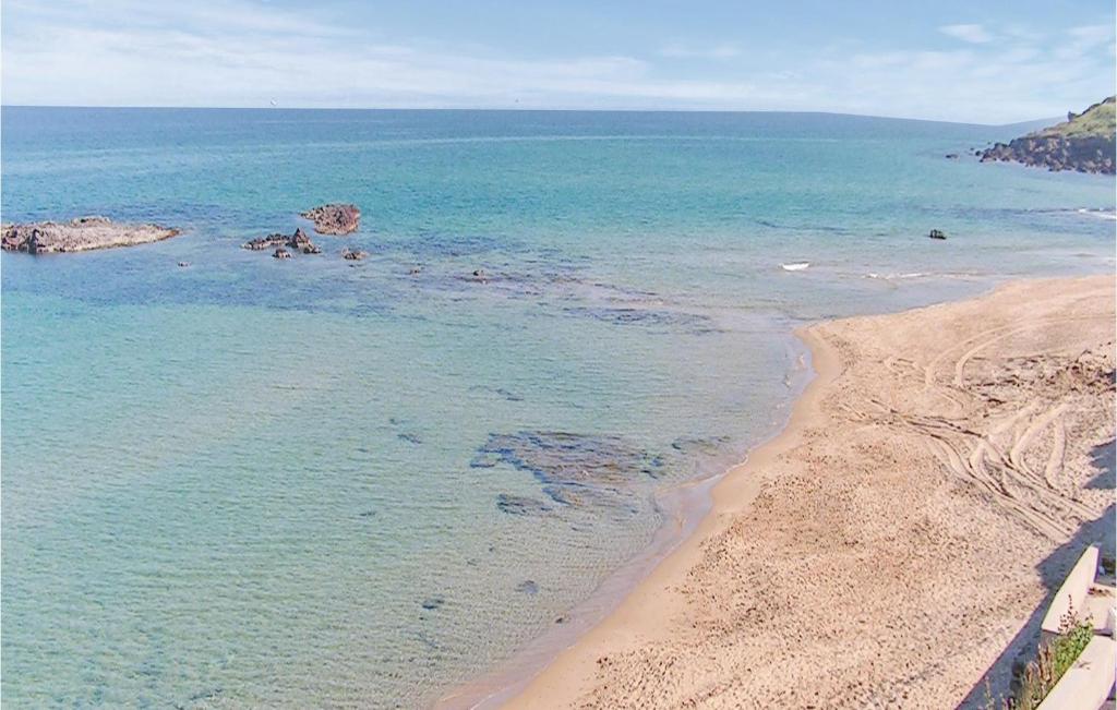 an aerial view of a beach and the ocean at Ibiscus Trilo 9 in Castelsardo