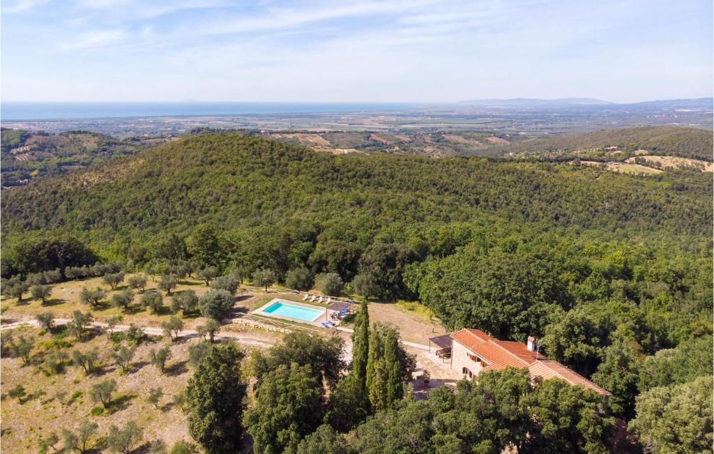 an aerial view of a house in the hills with a swimming pool at Camberotti Casale in Sassetta