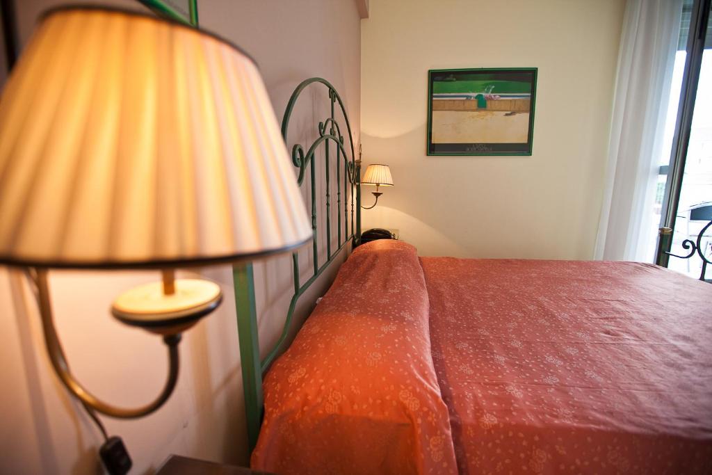 Postel nebo postele na pokoji v ubytování Hotel Rainero