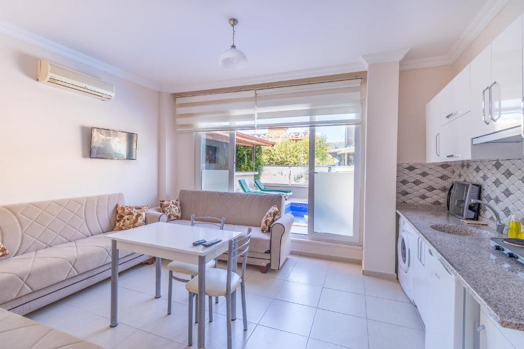 a kitchen and living room with a couch and a table at Apartments Near to City Center and Beach in Marmaris