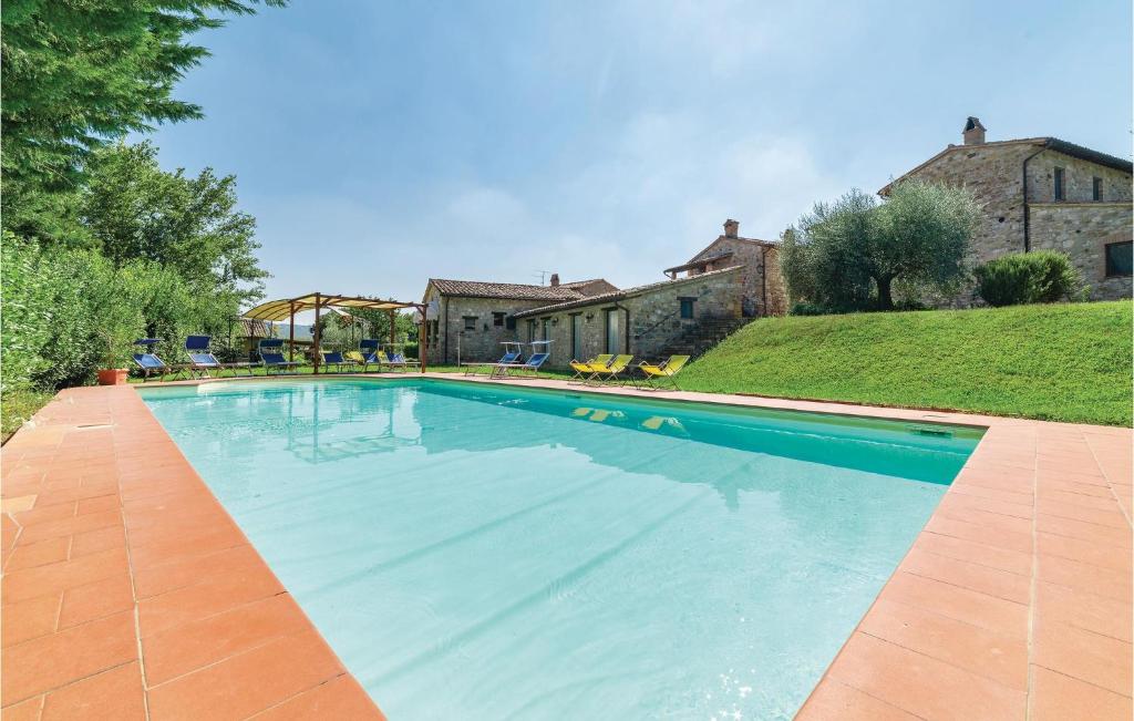 a swimming pool in front of a house at Apartment Todi PG 28 in Canonica