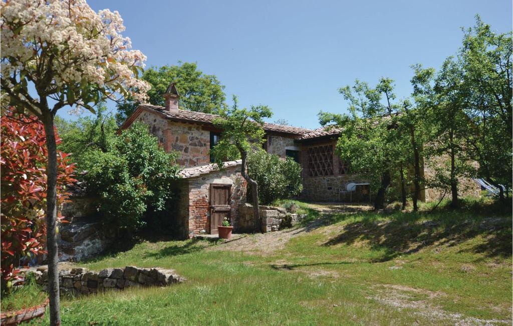 an external view of a stone house with a yard at La Casetta in Montepulciano