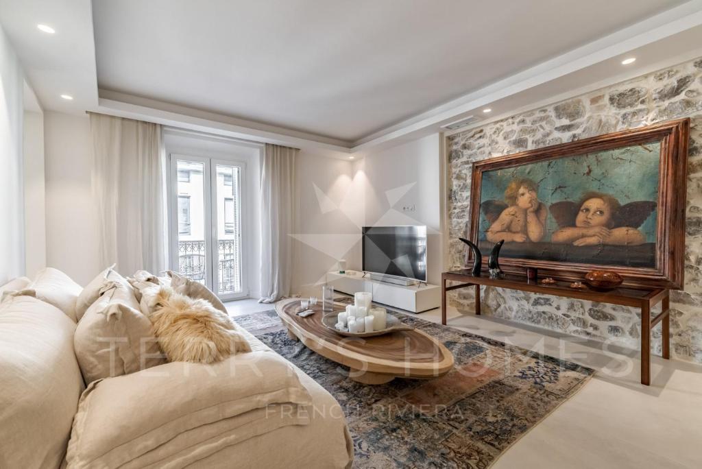 a living room with a couch and a painting on the wall at Paula by Terry&#39;s Homes in Cannes