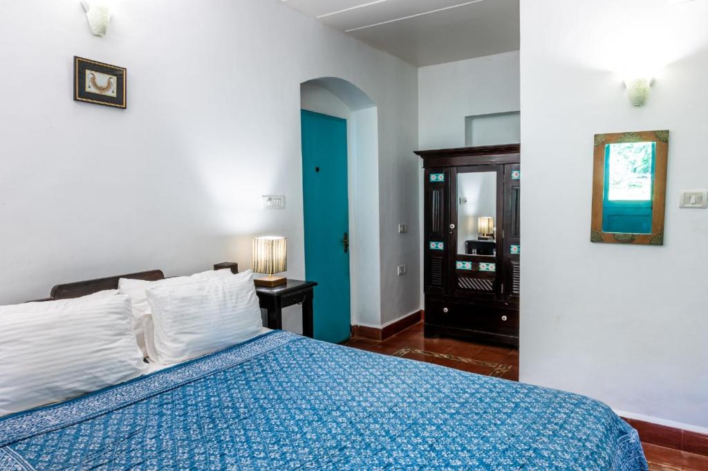 Postel nebo postele na pokoji v ubytování Island House Goa