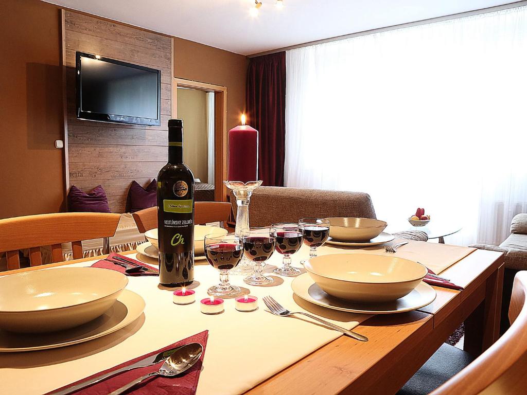 a table with plates of food and wine glasses on it at Apartments City Centre in Bratislava