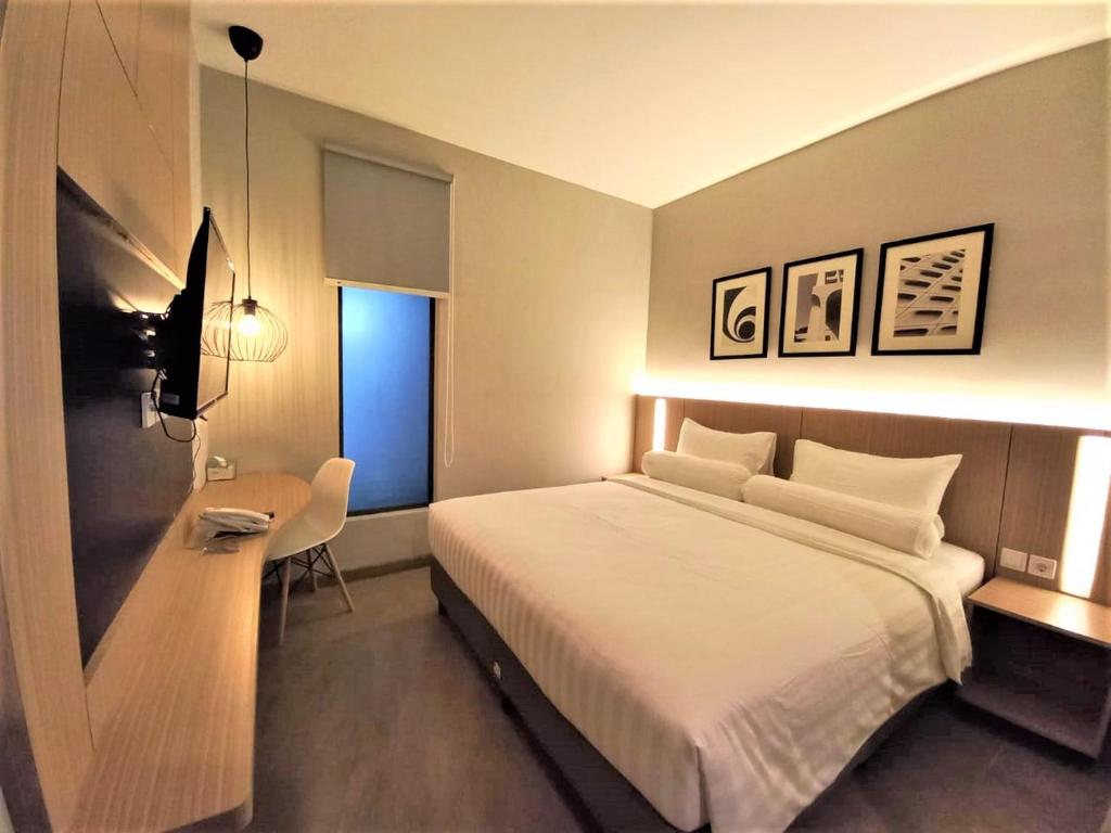 Postel nebo postele na pokoji v ubytování Front One King Hotel Tuban
