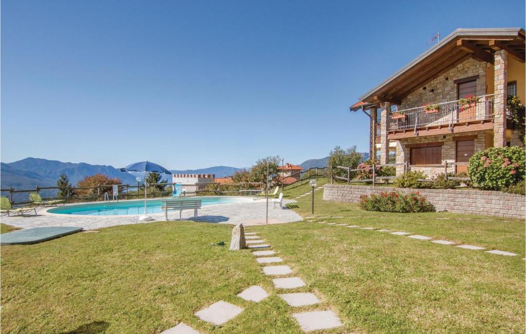a house with a swimming pool in a yard at Panorama 1 in Due Cossani