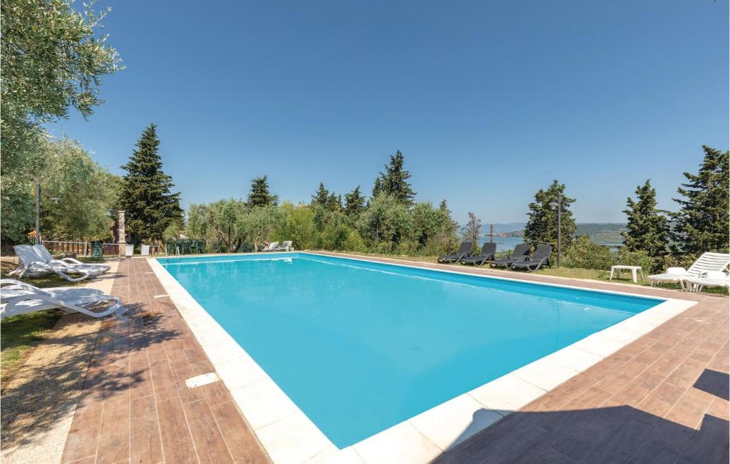 a large swimming pool with blue water at Il Poeta in Montemelino