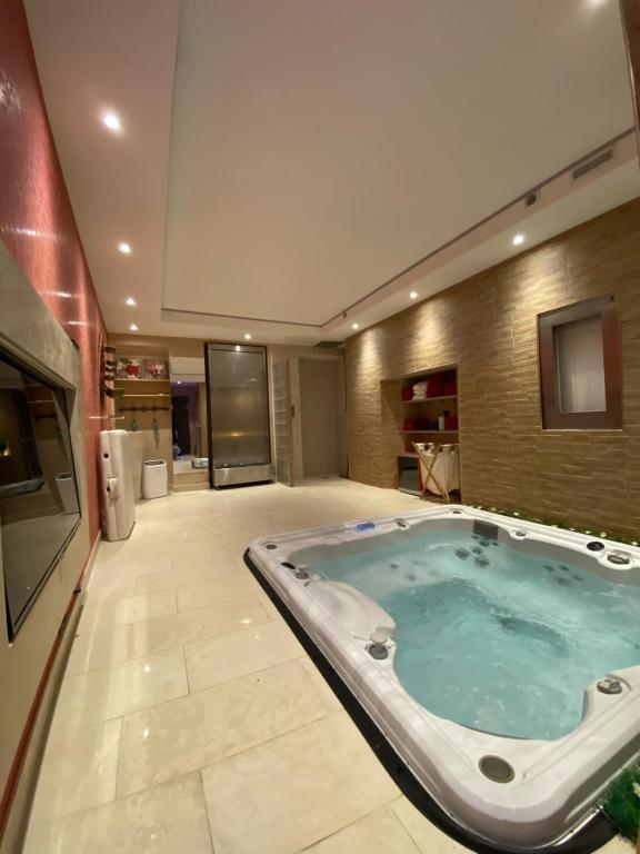 a jacuzzi tub in the middle of a room at Le Mimosa in Saint-Saturnin-de-Lucian