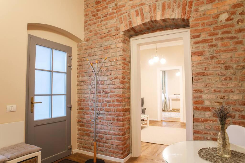 a room with a brick wall and a door at Charming Apartment in Historical City Center in Timişoara