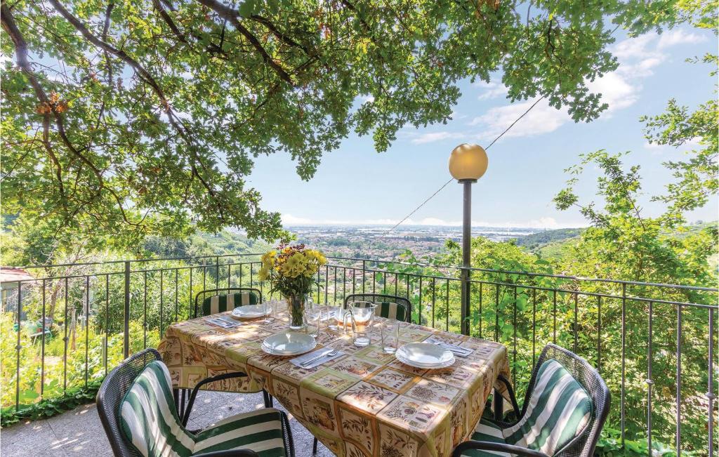 a table and chairs on a balcony with a view at Casa Eliana in Carrara