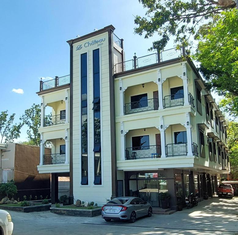 a building with a car parked in front of it at Le Chateau Residences in Bacolod