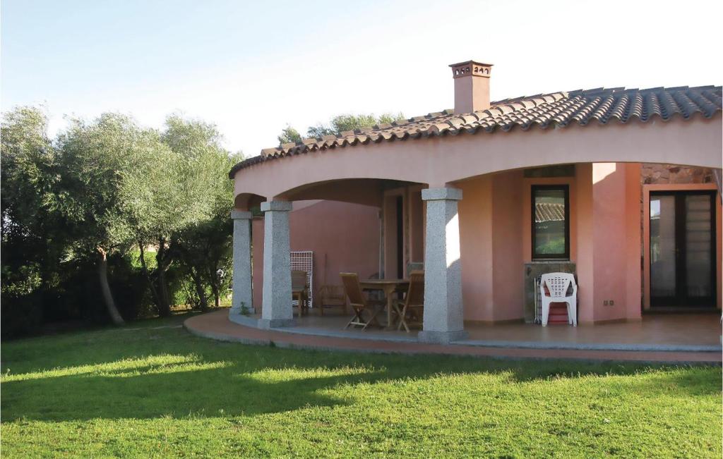 a house with a patio with a table and chairs at Beautiful Home In Costa Rei -ca- With Wifi in Monte Nai