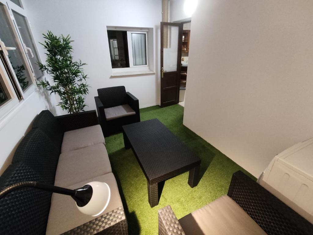 uma sala de estar com um sofá e uma mesa em Apartamento Covadonga em Gijón