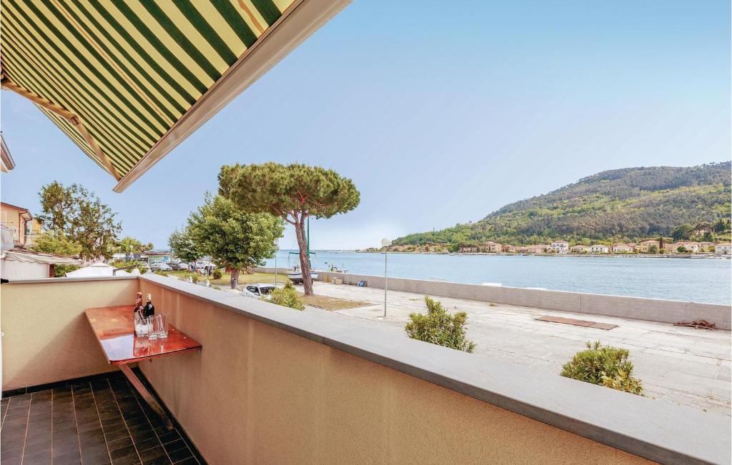a balcony with a table and a view of the water at Casa Manuela in Marinella di Sarzana