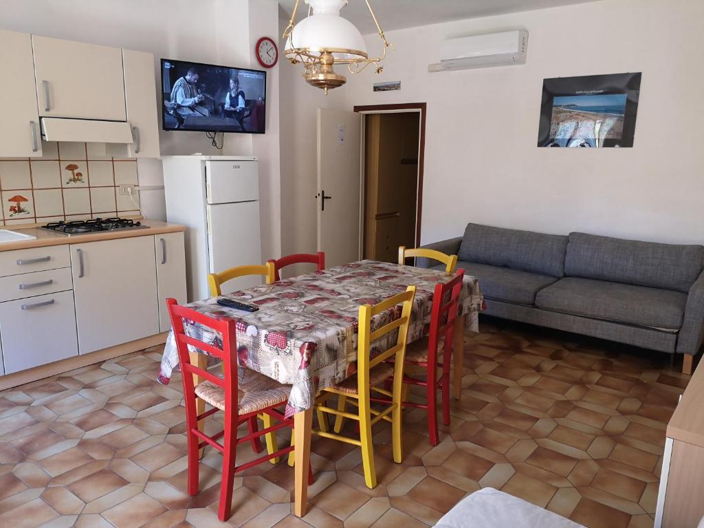 a kitchen and living room with a table and chairs at IL TRITONE in Marina di Bibbona