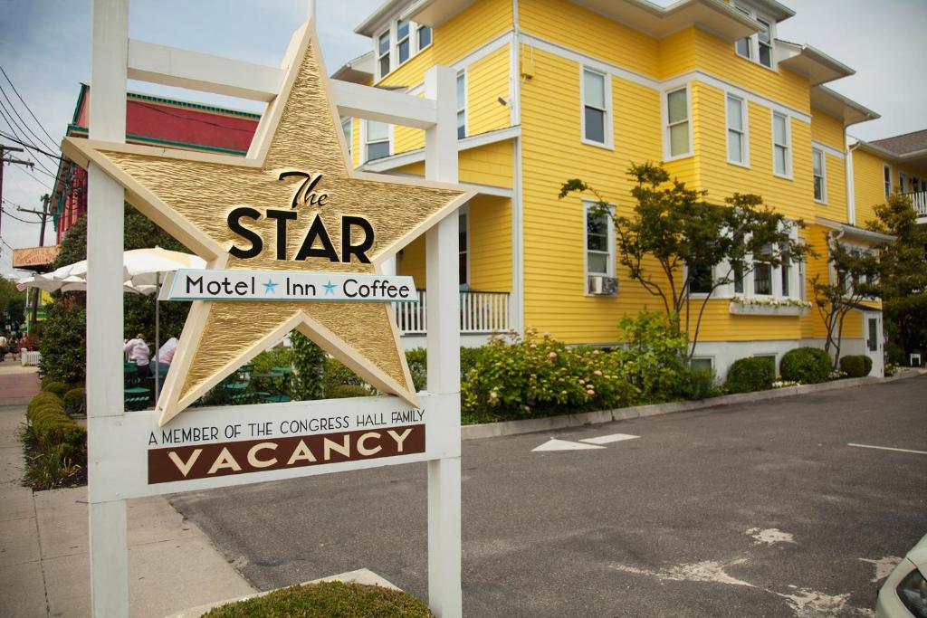 a sign in front of a yellow house at The Star Inn in Cape May