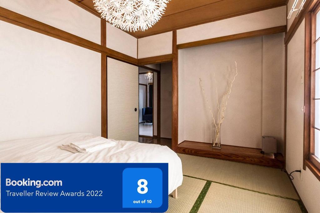 een slaapkamer met een bed en een kroonluchter bij Ikebukuro Yamase Building #GR1 in Tokyo