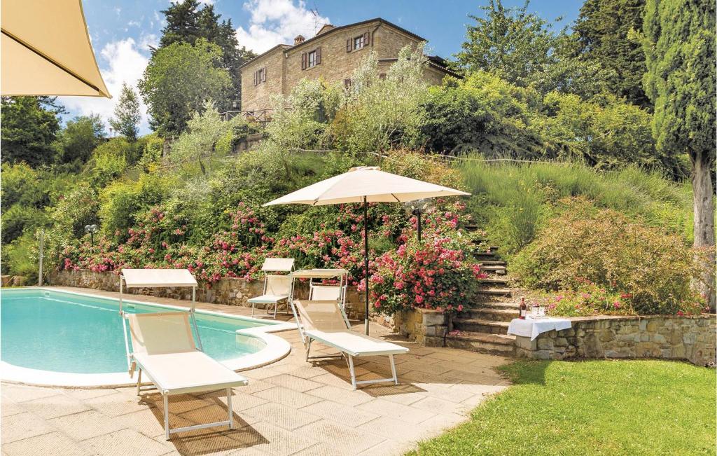 a patio with chairs and an umbrella next to a pool at San Martin in Morra