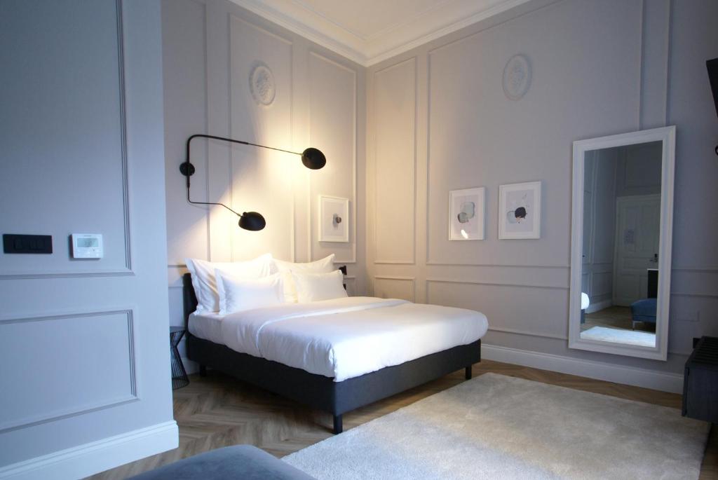 a bedroom with a white bed and a mirror at Fingerprint Luxury Apartments 3 in Zagreb