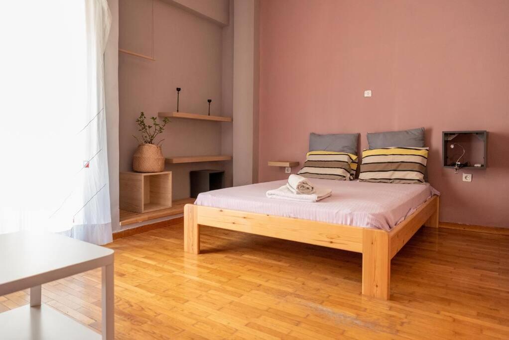 a bedroom with a wooden bed in a room at Nice Apartment Near City Center in Athens