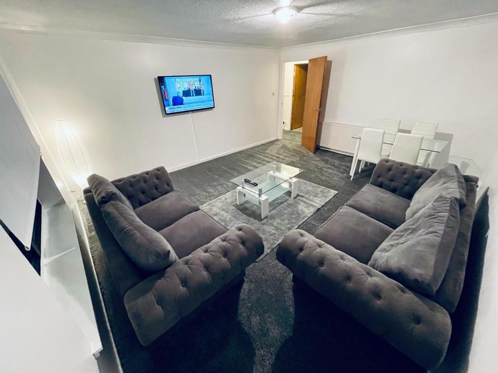 a living room with a couch and a table at Modern 2 Bedroom Apartment With Free Parking in Glasgow
