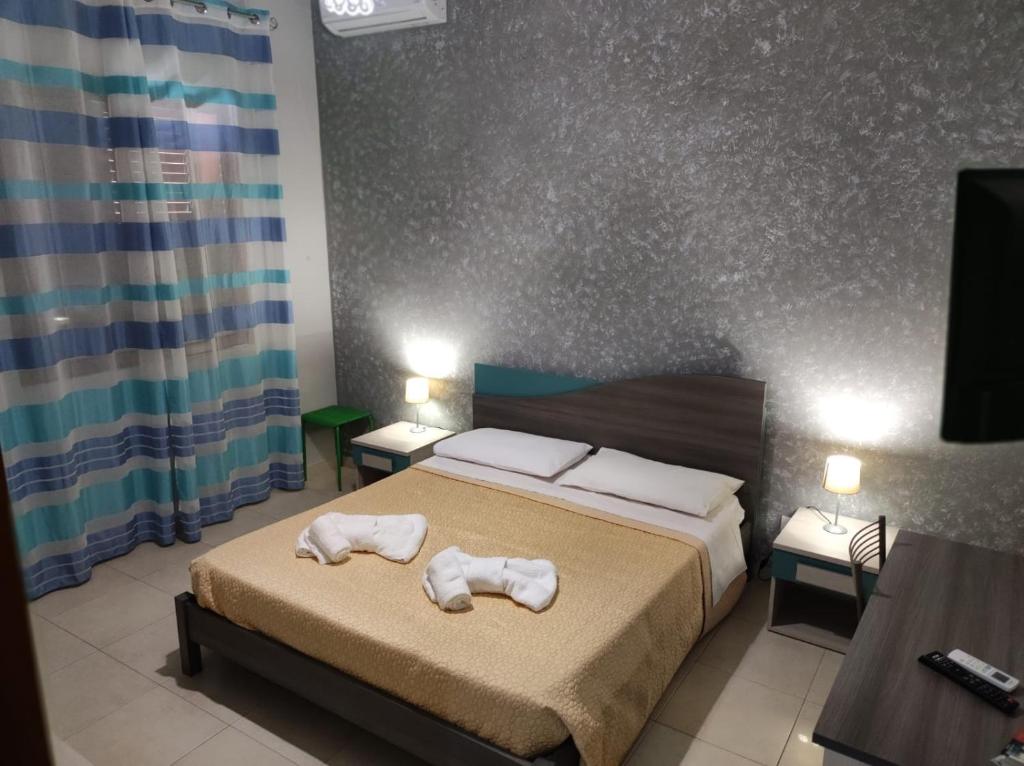 Postel nebo postele na pokoji v ubytování B&B AMURI RANNI