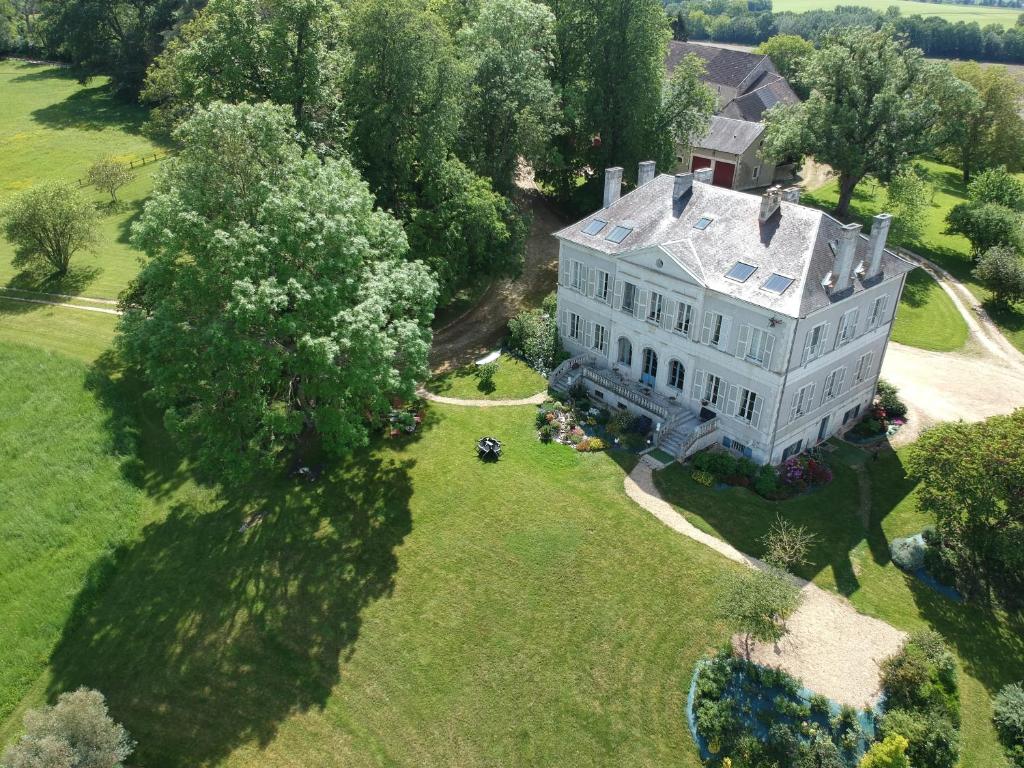 an aerial view of a large white house on a field at B&amp;B Château de Preuil in Vallenay