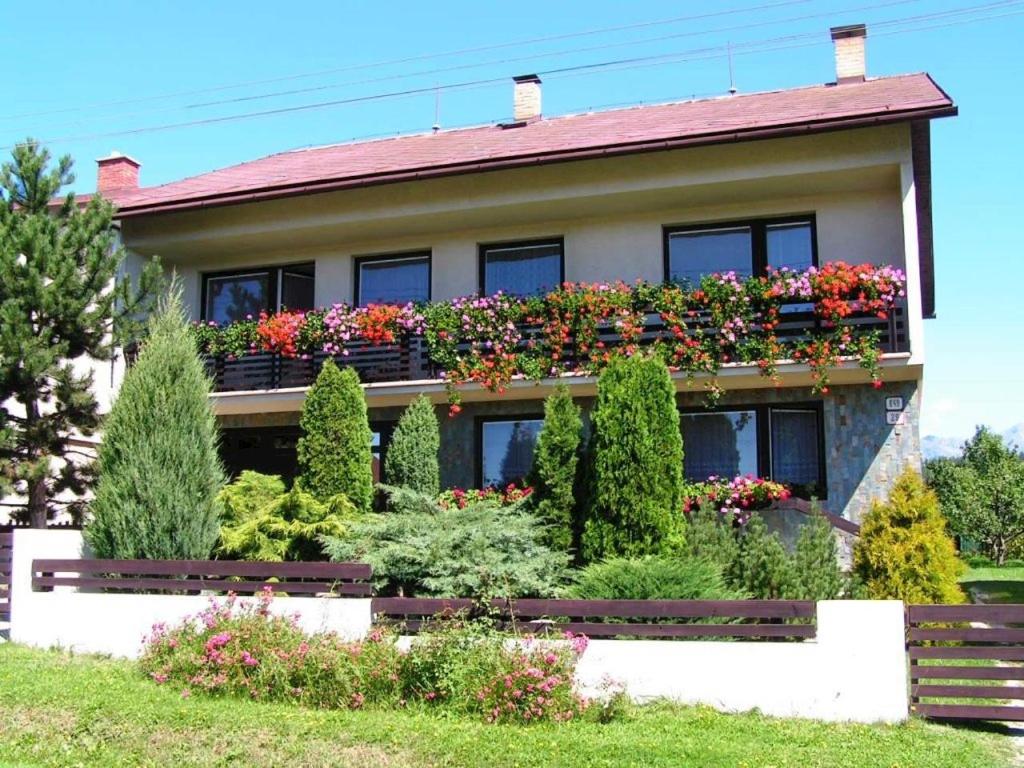 a house with flower boxes on the side of it at Apartmán Vika in Štrba