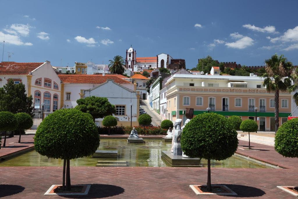 a view of a city with a fountain and buildings at Encosta Retreat in Silves