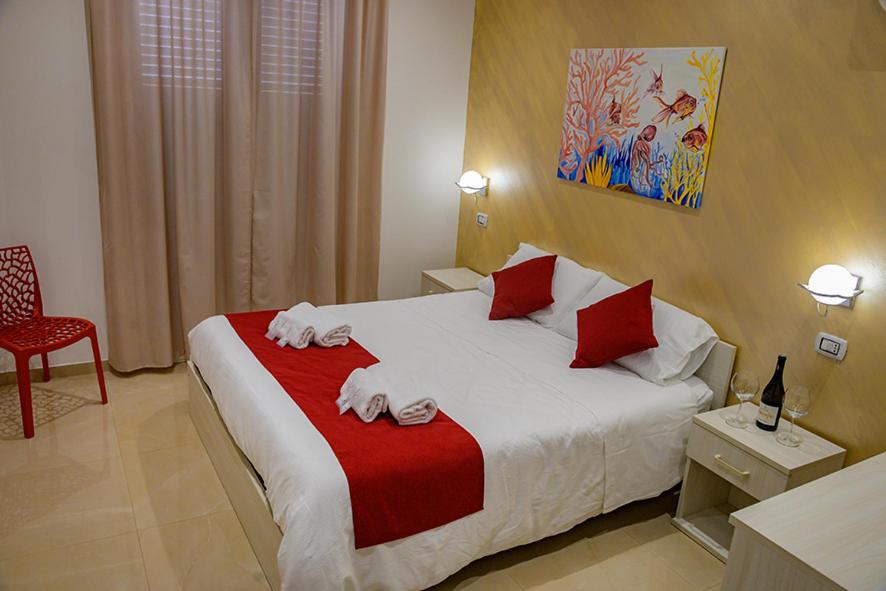 Posteľ alebo postele v izbe v ubytovaní Corallo Rosso B&B