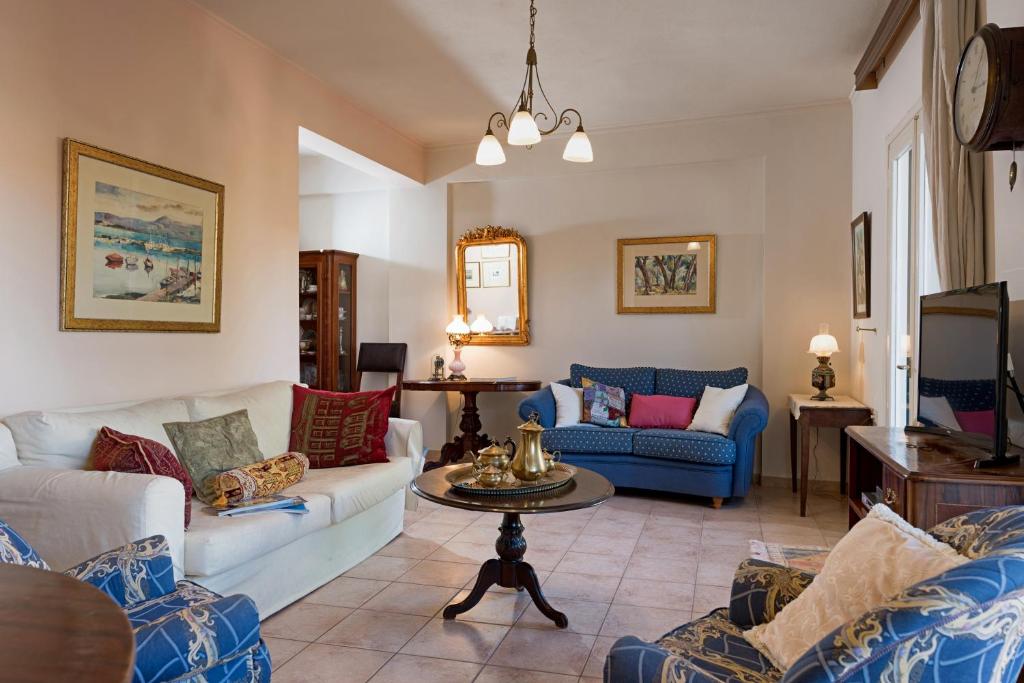 a living room with two couches and a tv at Corfu Garitsa Spacious Apartment in Corfu