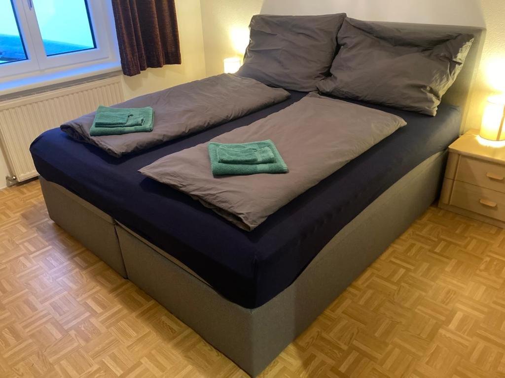 a bed with two green towels on top of it at Apartment Peterl in Alpl