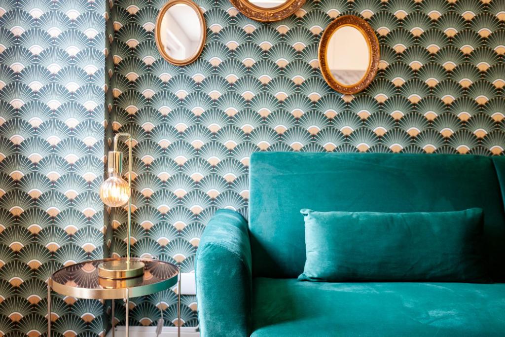 a living room with a blue couch and a table at Embaixador Apartments&Suites in Lisbon
