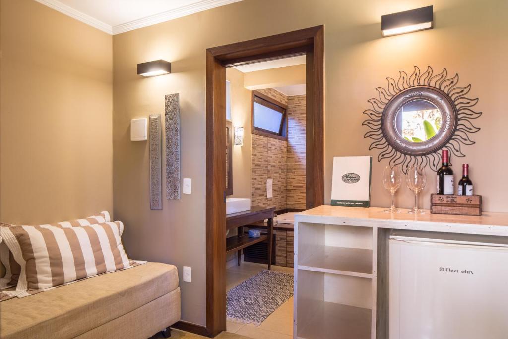 a living room with a counter and a mirror at Pousada Maya in Alto Paraíso de Goiás