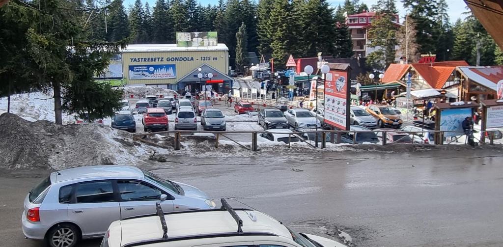 a group of cars parked in a parking lot at The Green King in Borovets