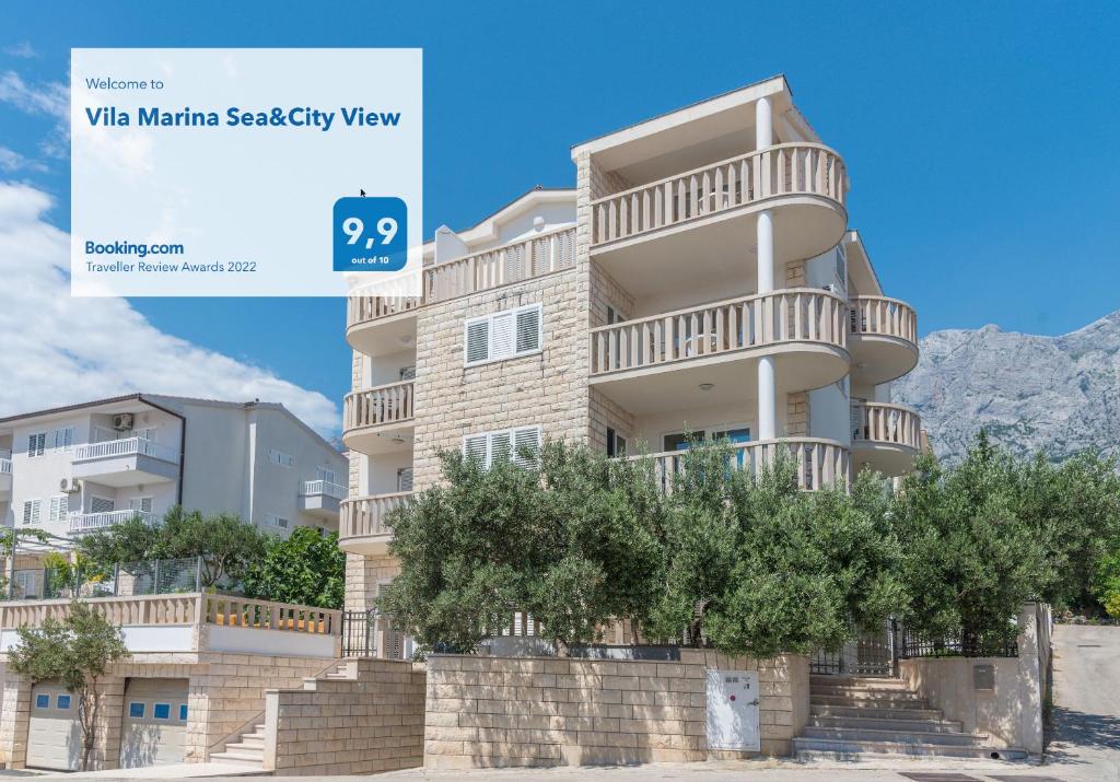 a large apartment building with stairs in front of it at Vila Marina Sea&City View in Makarska