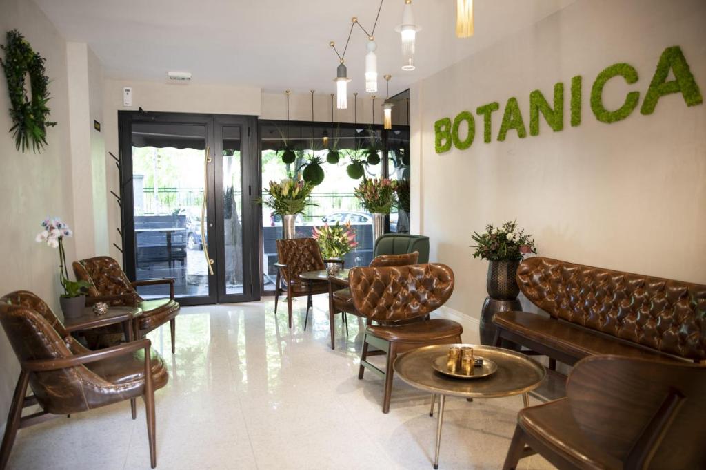 a waiting room with chairs and tables in a store at Hotel Botanica in Belgrade