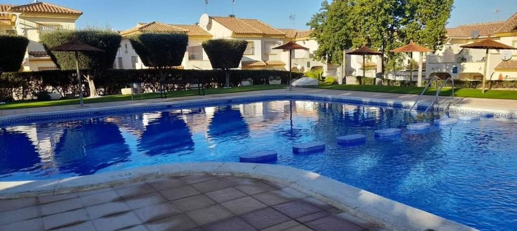 a large swimming pool in a yard with houses at CASA BELLA in Los Altos