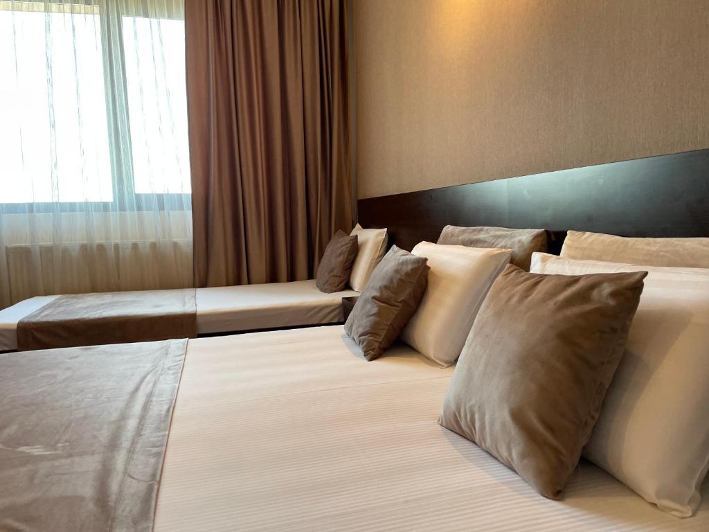 Postel nebo postele na pokoji v ubytování Hotel Athos